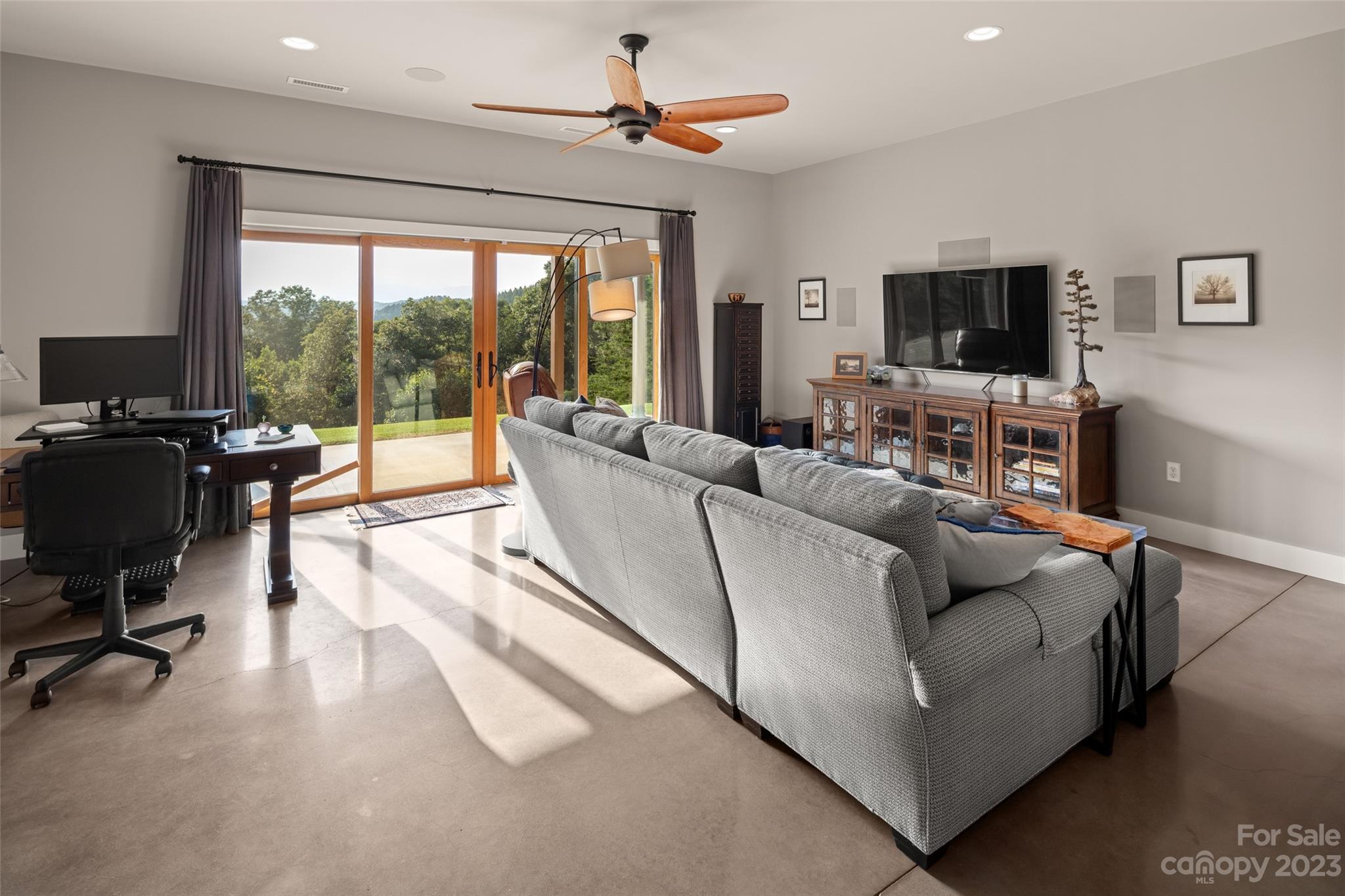 285 Red Tail Trail Mill Spring Mill Spring, NC 28756 - Photo 30 of 48 a living room with furniture a flat screen tv and a large window