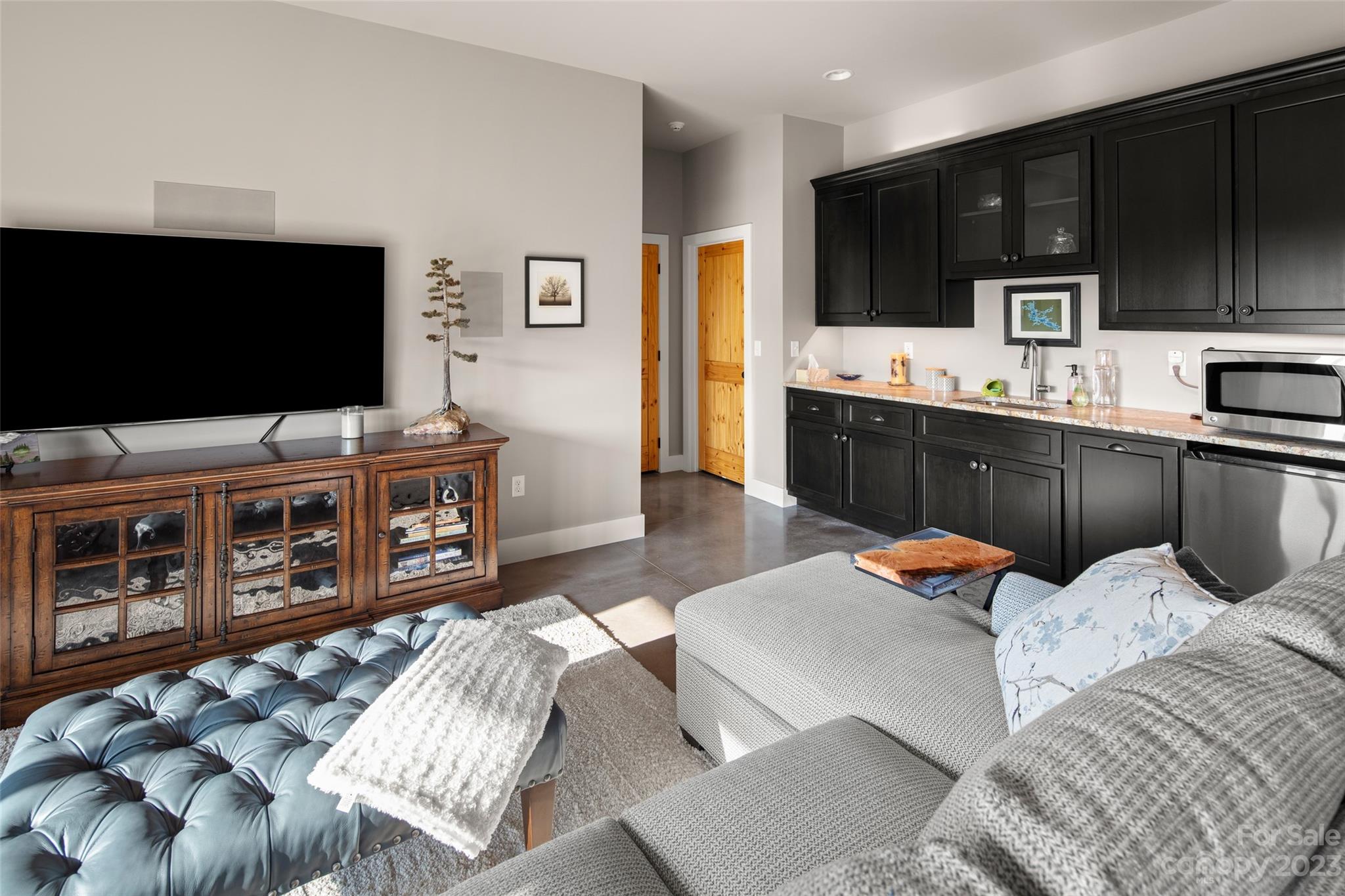 285 Red Tail Trail Mill Spring Mill Spring, NC 28756 - Photo 32 of 48 a living room with furniture and a flat screen tv