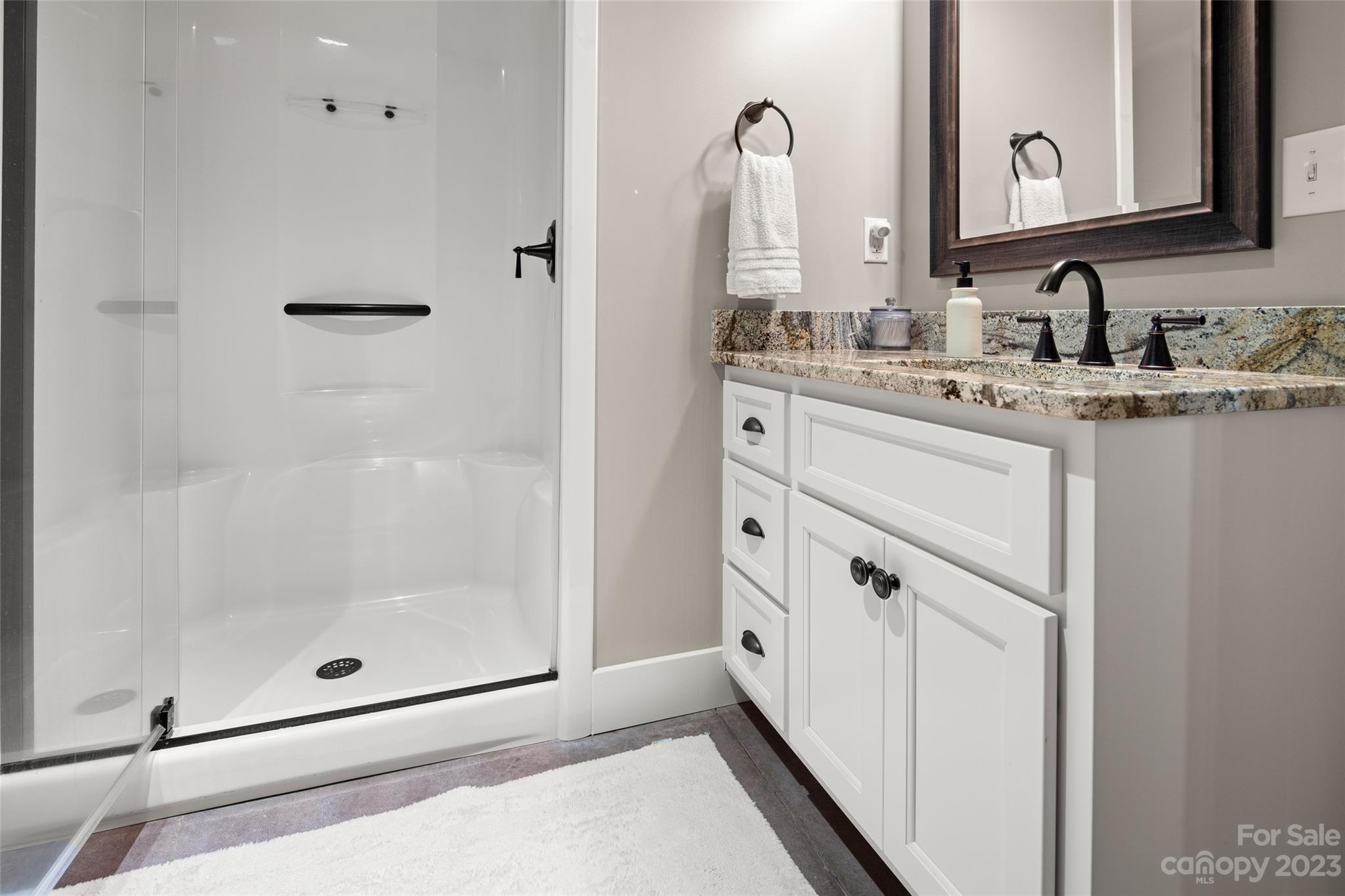 285 Red Tail Trail Mill Spring Mill Spring, NC 28756 - Photo 35 of 48 a bathroom with a mirror sink and vanity