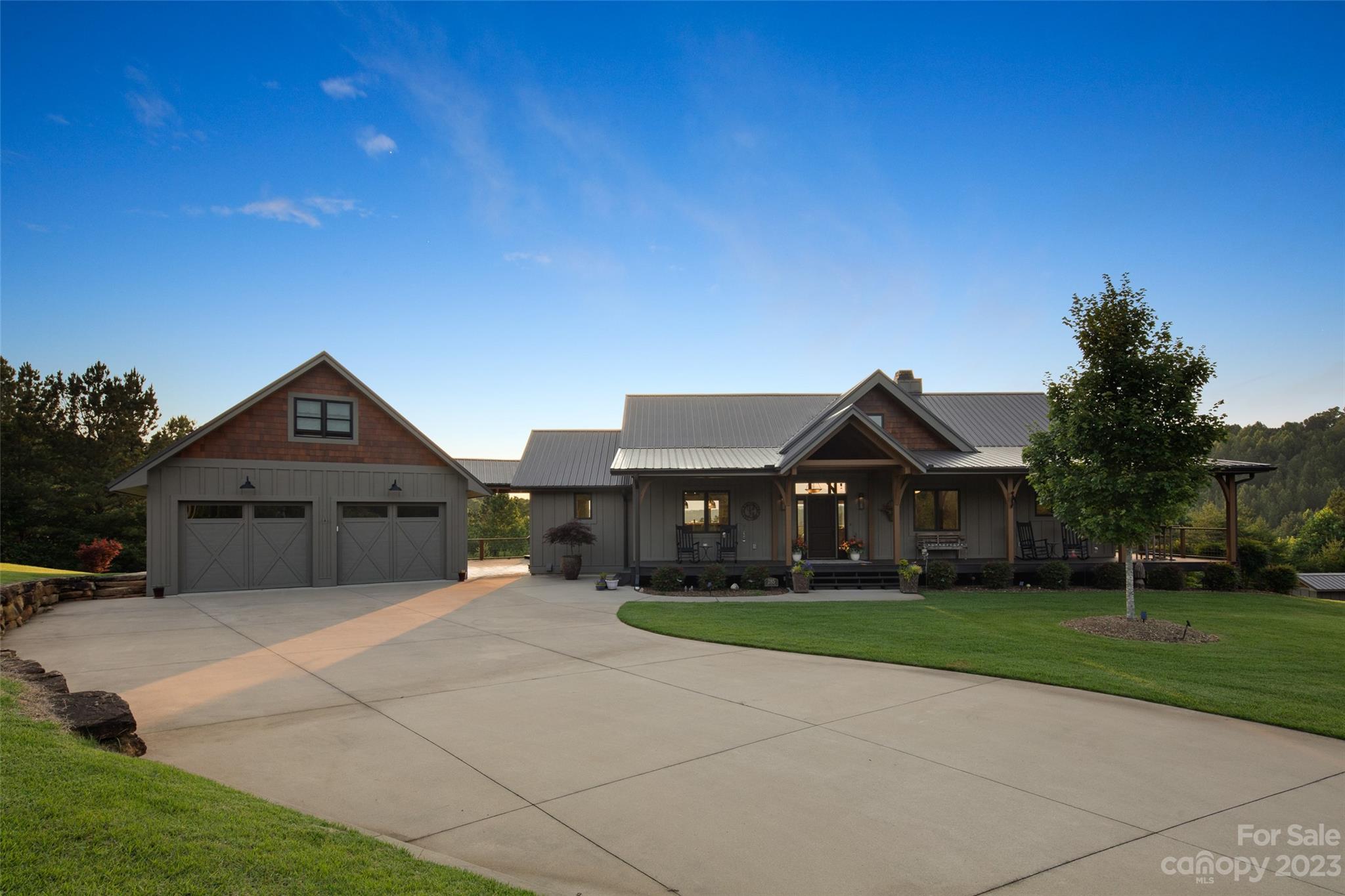 285 Red Tail Trail Mill Spring Mill Spring, NC 28756 - Photo 5 of 48 a front view of a house with a yard and garage