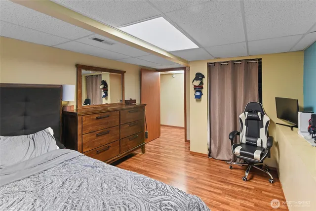 a bedroom with a bed and wooden floor