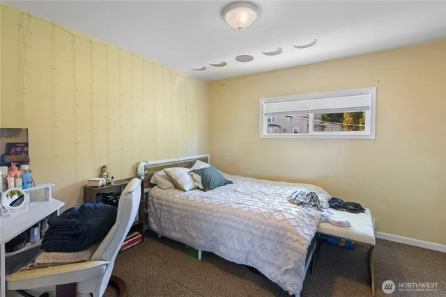 a bedroom that has a bed and a chair in it