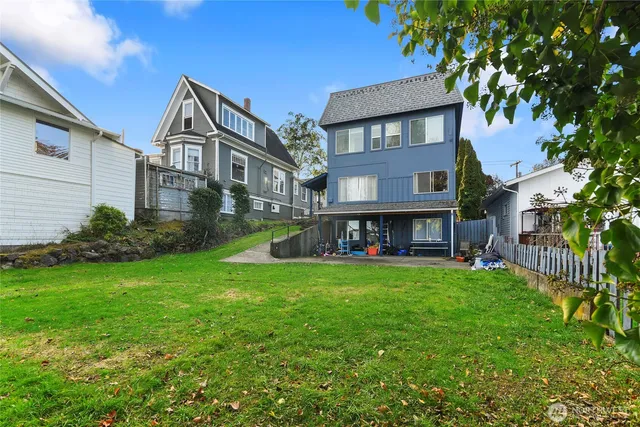 a view of a house with a yard and sitting area