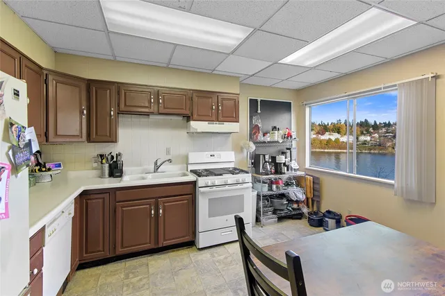 a kitchen with a sink a stove and cabinets