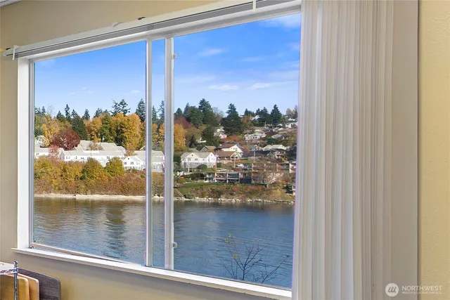a view of a glass door with a lake view