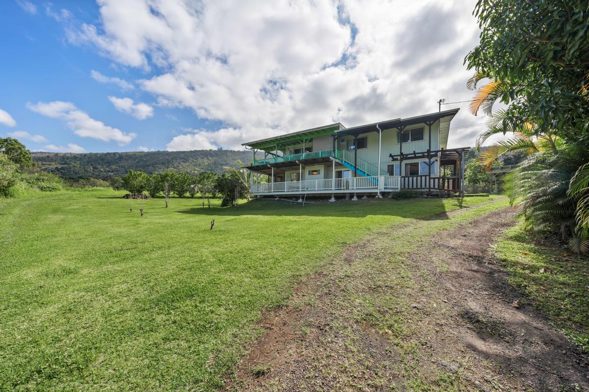 83-5434 Middle Keei Road Captain Cook, HI 96704 - Photo 1 of 30 a view of a house with a big yard and large trees