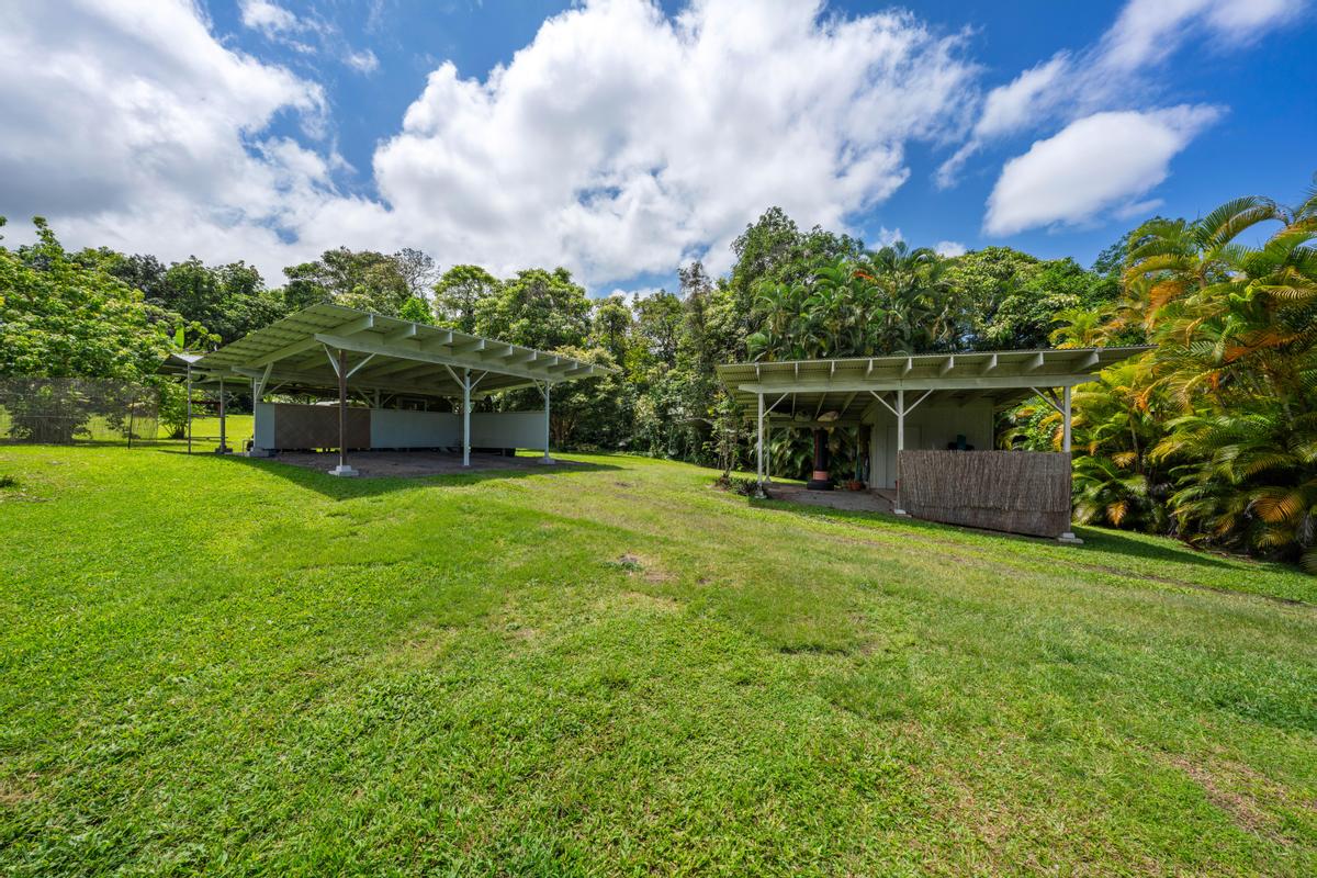 83-5434 Middle Keei Road Captain Cook, HI 96704 - Photo 15 of 30 a view of a garden with a building in the background