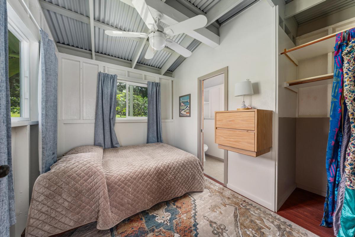 83-5434 Middle Keei Road Captain Cook, HI 96704 - Photo 23 of 30 a bedroom with a bed wooden floor and window