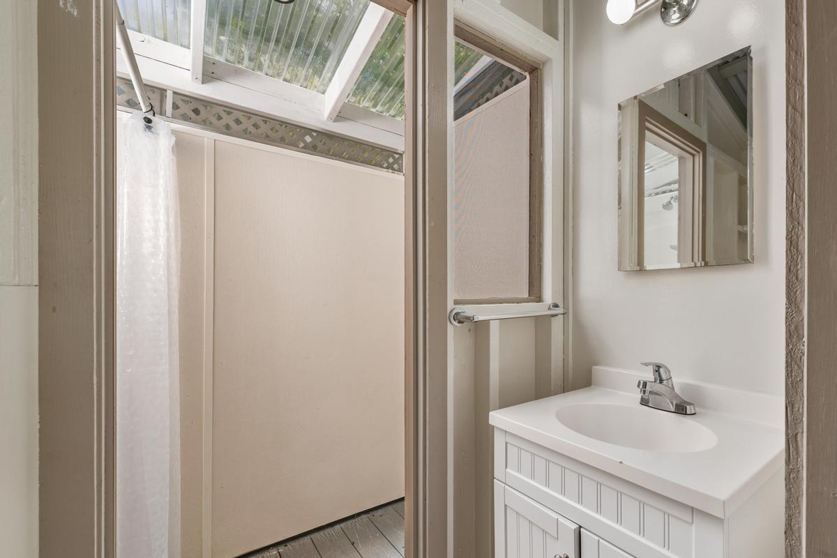 83-5434 Middle Keei Road Captain Cook, HI 96704 - Photo 24 of 30 a bathroom with a sink a mirror and shower