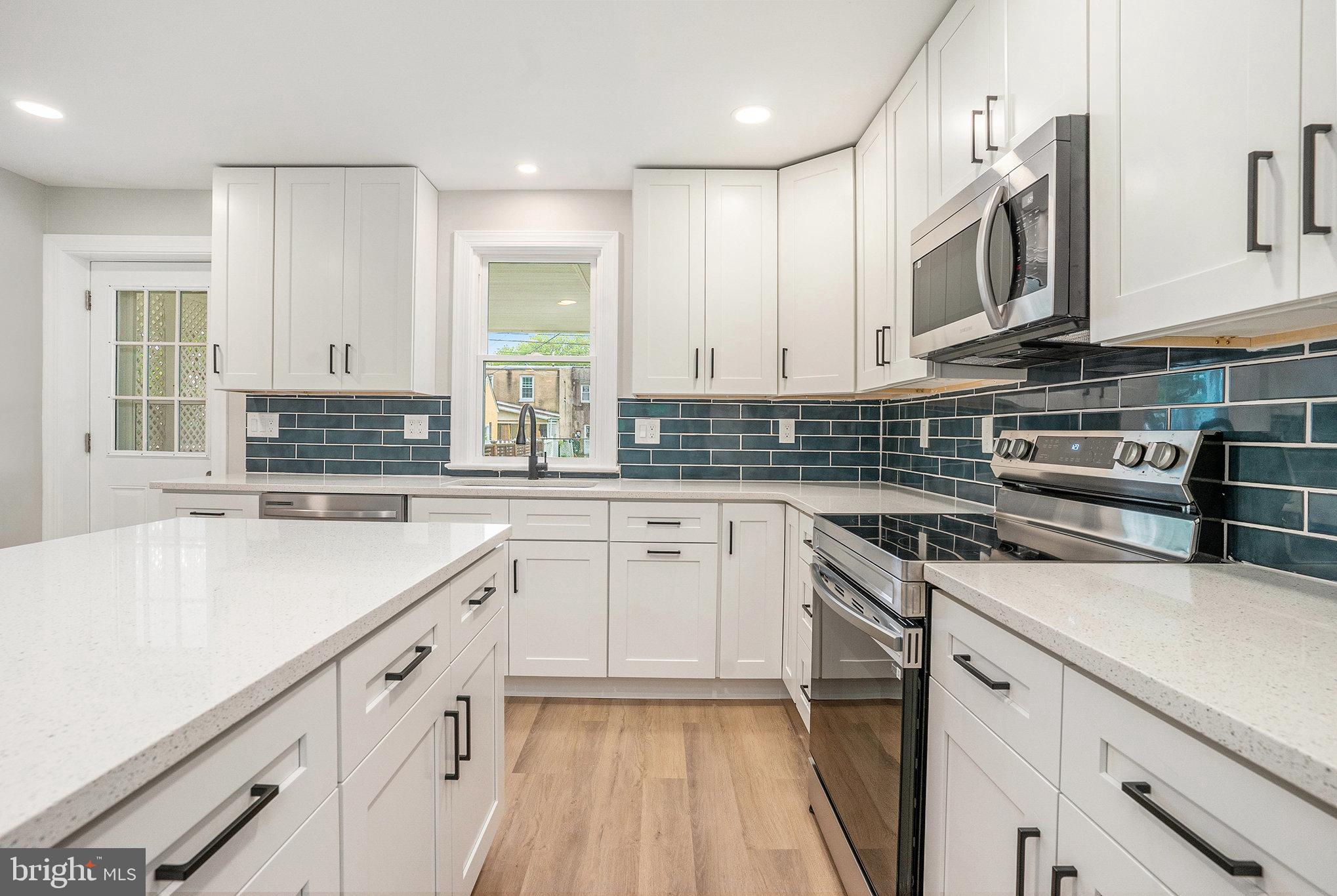 429 East 12th Avenue Conshohocken, PA 19428 - Photo 11 of 34 a kitchen with stainless steel appliances granite countertop a stove sink and cabinets