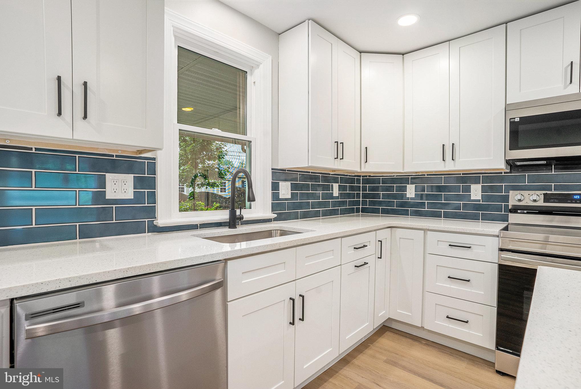 429 East 12th Avenue Conshohocken, PA 19428 - Photo 10 of 34 a kitchen with stainless steel appliances white cabinets and a sink