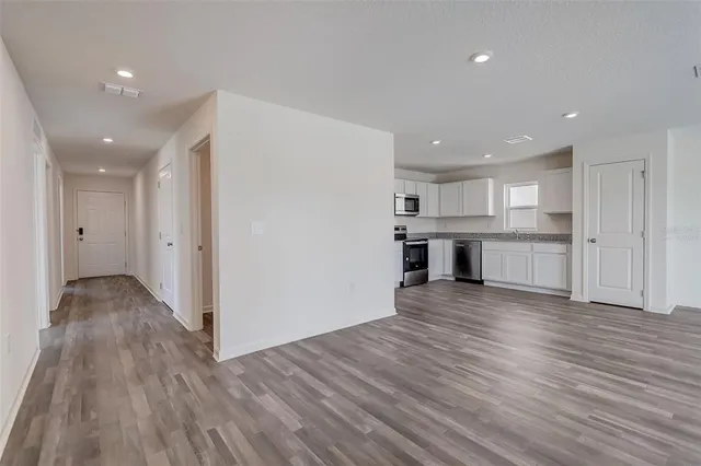 a view of kitchen with wooden floor and electronic appliances
