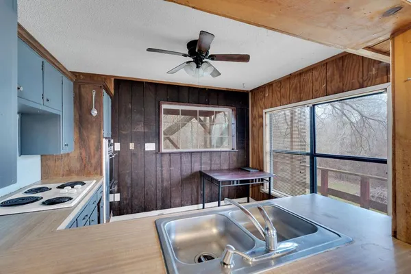 a view of a hallway with wooden floor and workspace