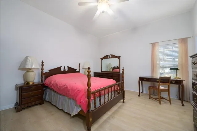 a bedroom with a bed and a table