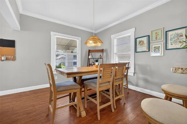 a view of a dining room with furniture window and wooden floor