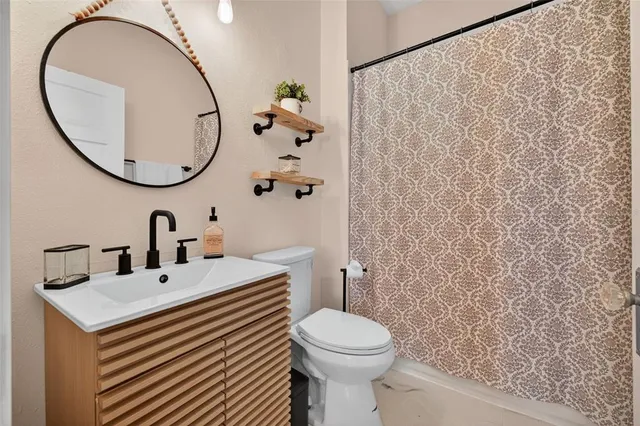 a bathroom with a sink a mirror and a toilet