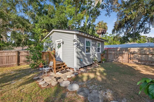 a view of a house with backyard and sitting area