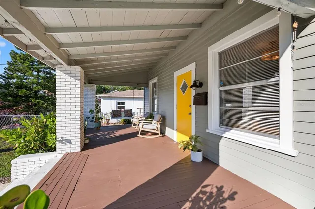 a bedroom with furniture and a large window