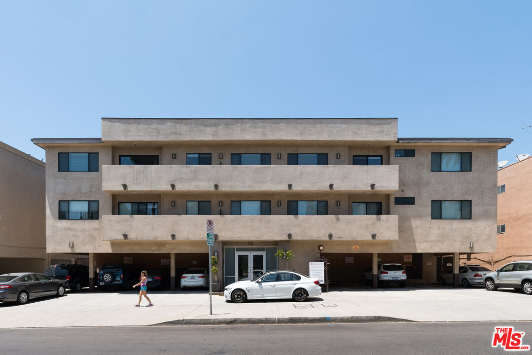 a view of a building with a barbeque and car parked