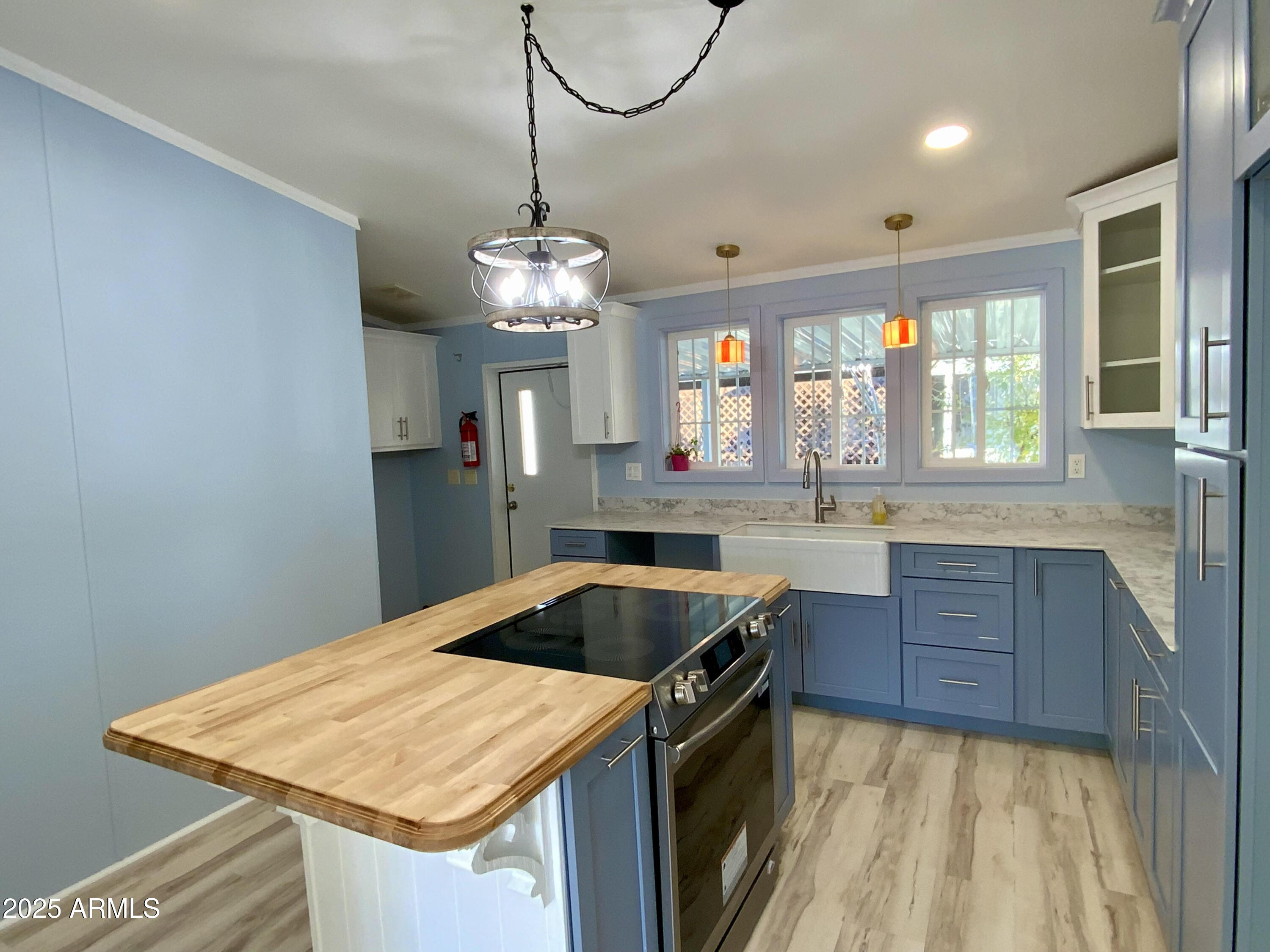 a kitchen that has a sink a stove and a table