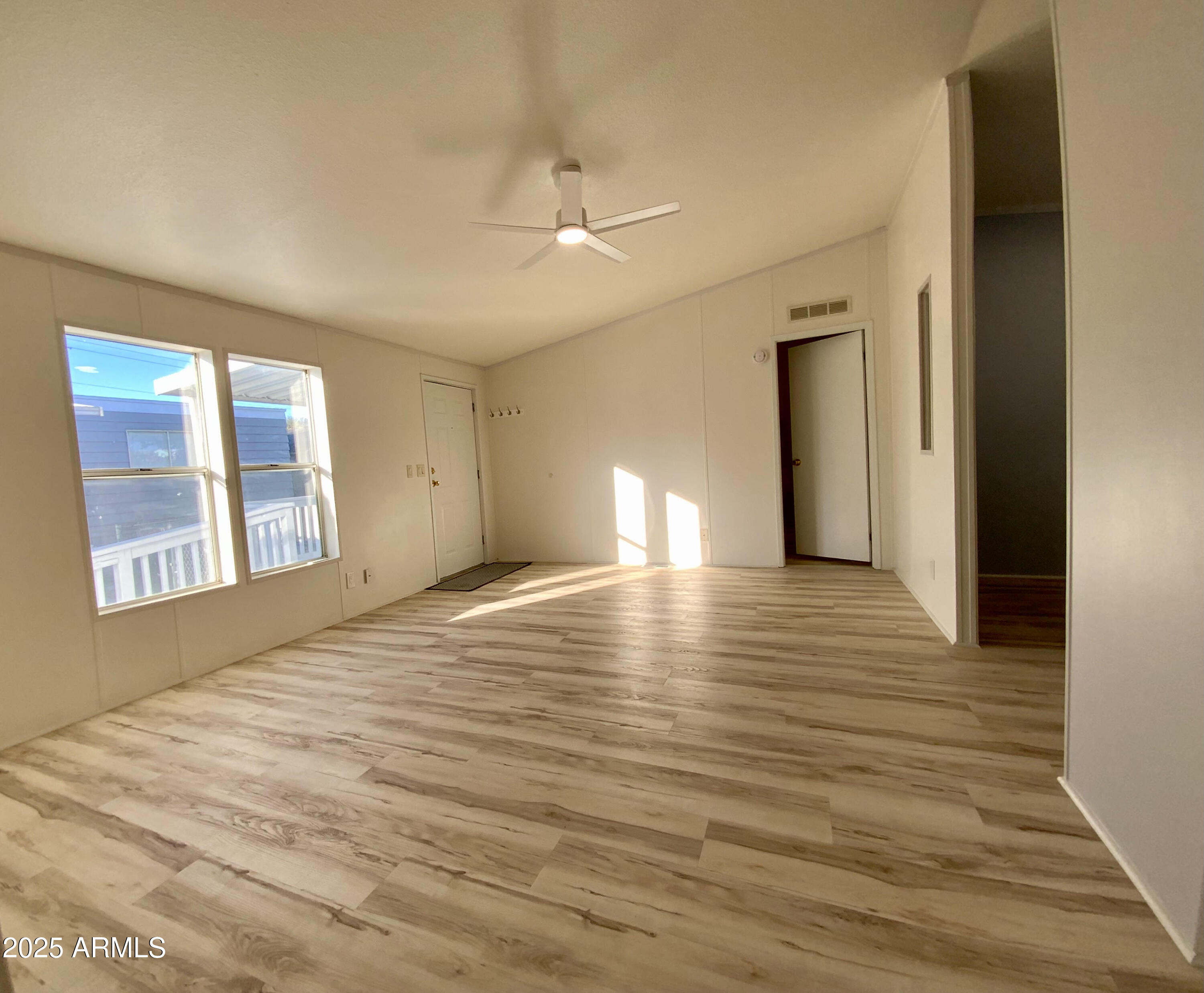 723 Finnie Flat Road, Unit 132 Camp Verde, AZ 86322 - Photo 13 of 58 a view of an empty room with wooden floor and a window