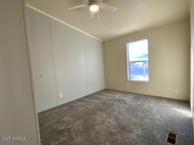 723 Finnie Flat Road, Unit 132 Camp Verde, AZ 86322 - Photo 38 of 58 an empty room with windows and fan