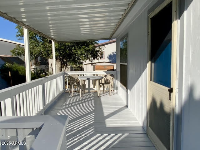 723 Finnie Flat Road, Unit 132 Camp Verde, AZ 86322 - Photo 10 of 58 a view of a patio with table and chairs floor to ceiling window with wooden floor
