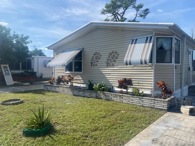 a view of a house with swimming pool and sitting area