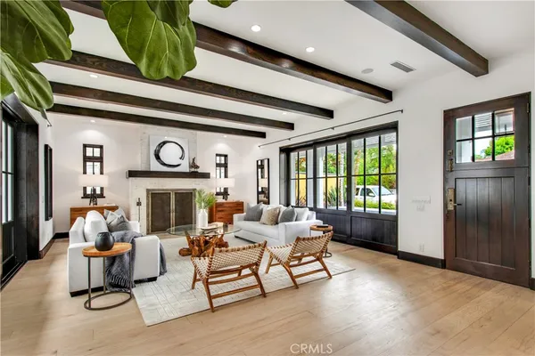 a kitchen with a stove a refrigerator and chairs