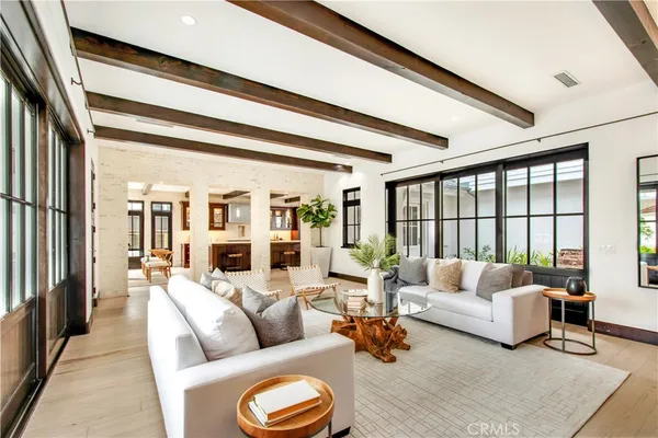 a living room with furniture and floor to ceiling windows