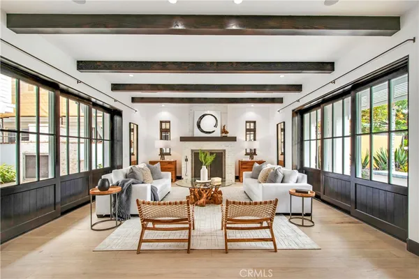 a living room with furniture and large windows