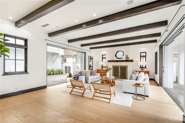 a living room with furniture a fireplace and a large window
