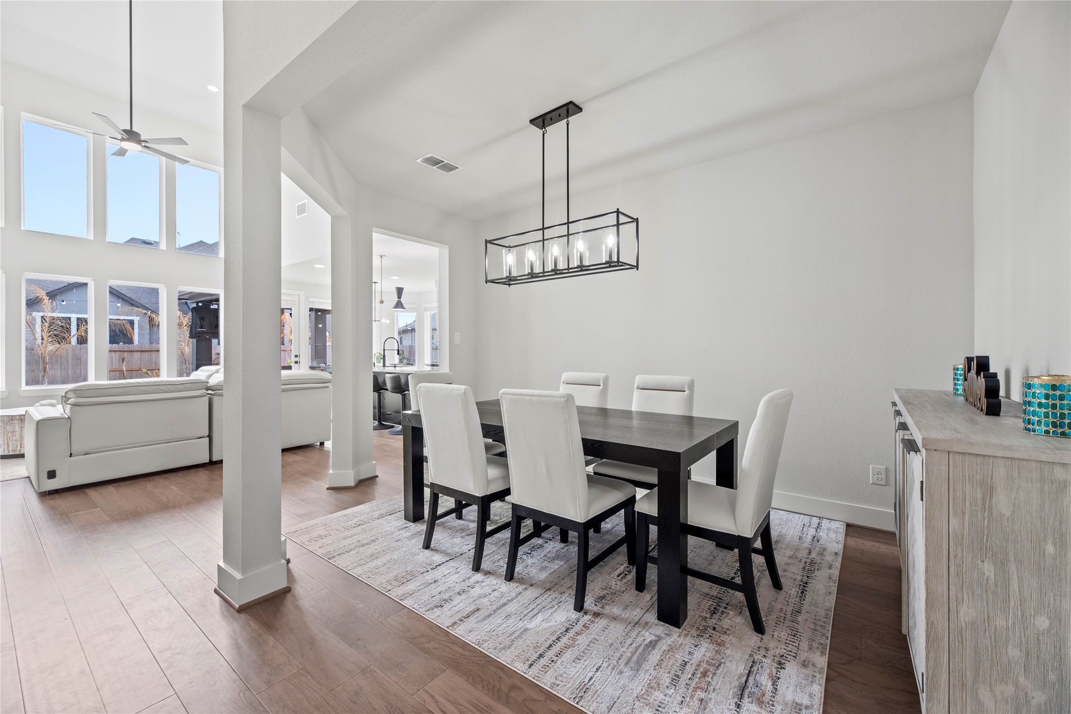 30155 GOLD FINCH Place Fulshear, TX 77441 - Photo 11 of 26 To the right of the entry is your formal dining space. Designer lighting can truly elevate the ambiance and aesthetic of a space, adding both functionality and style.