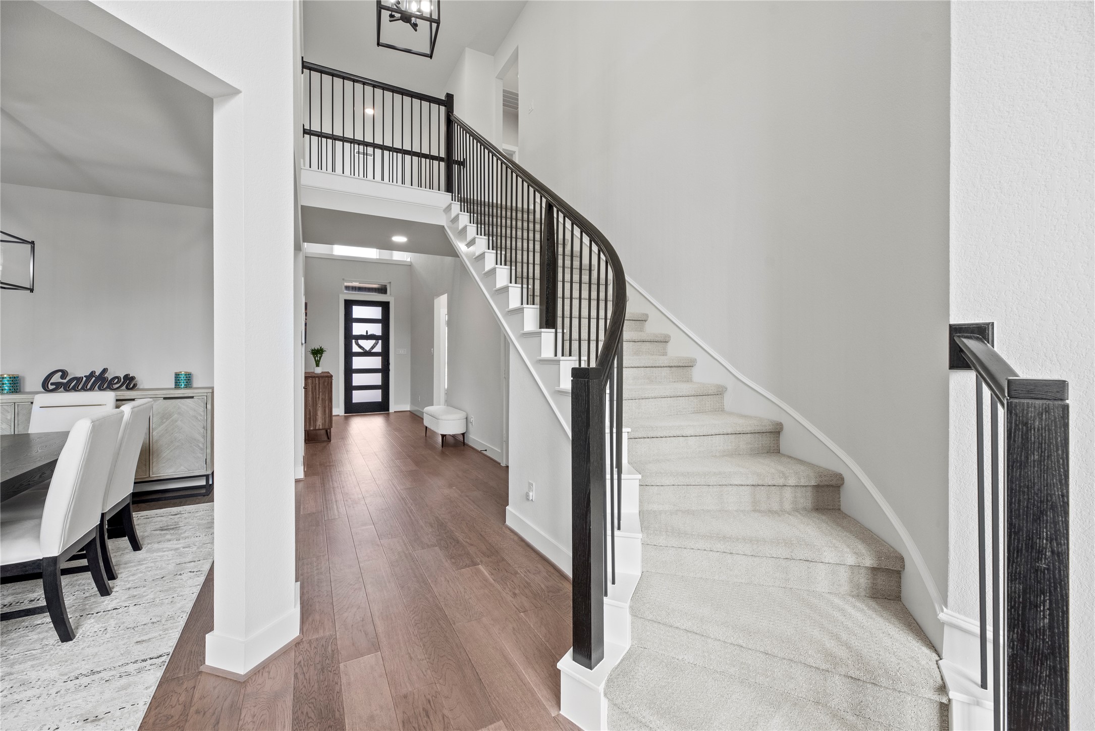 30155 GOLD FINCH Place Fulshear, TX 77441 - Photo 16 of 26 Even the staircase exudes elegance, featuring a harmonious blend of neutral hues and exquisitely crafted designer iron spindles.