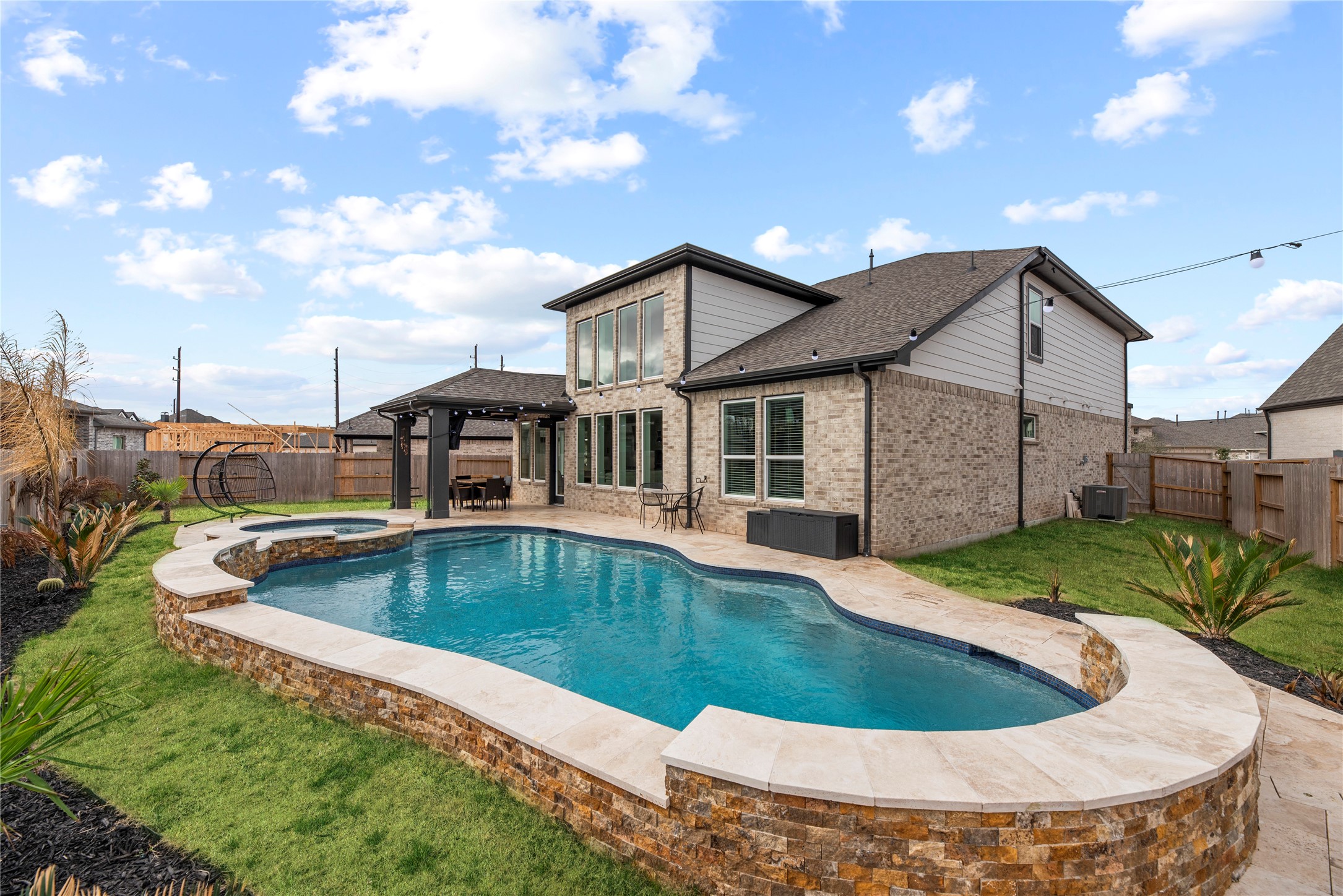 30155 GOLD FINCH Place Fulshear, TX 77441 - Photo 22 of 26 Step into the backyard oasis, where a sparkling pool with smartphone controls and a large yard create an inviting space to relax and enjoy sunny days.