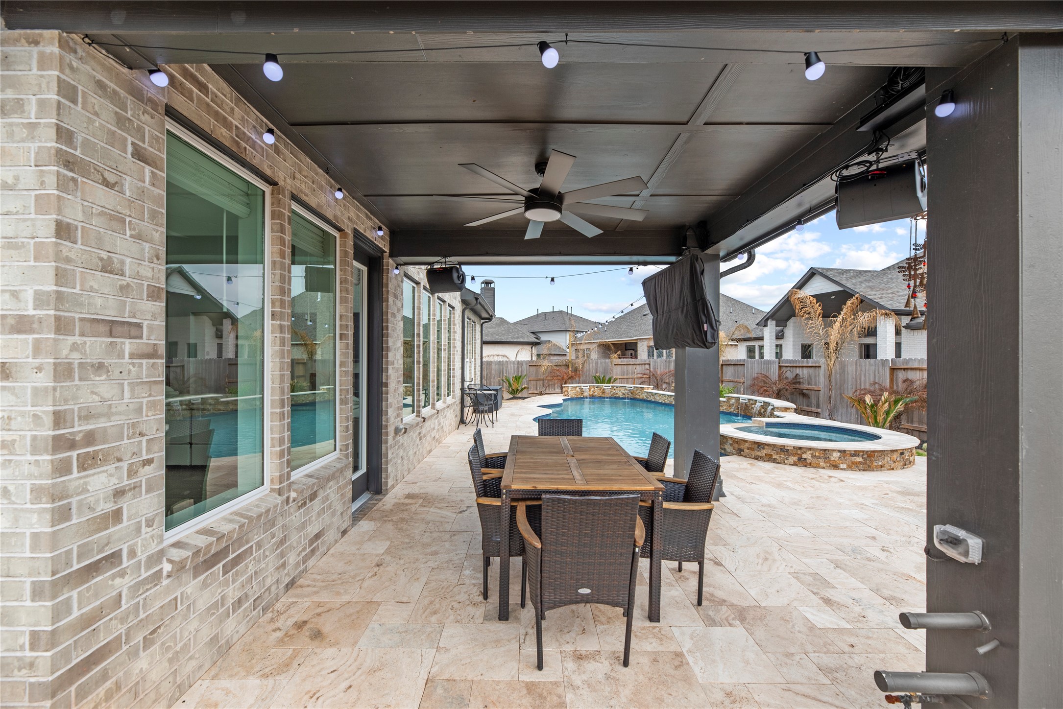 30155 GOLD FINCH Place Fulshear, TX 77441 - Photo 24 of 26 The extended covered patio offers plenty of space for a lounge setup or outdoor dining, creating a versatile area to enjoy the backyard. There is a natural gas line available for your grill!
