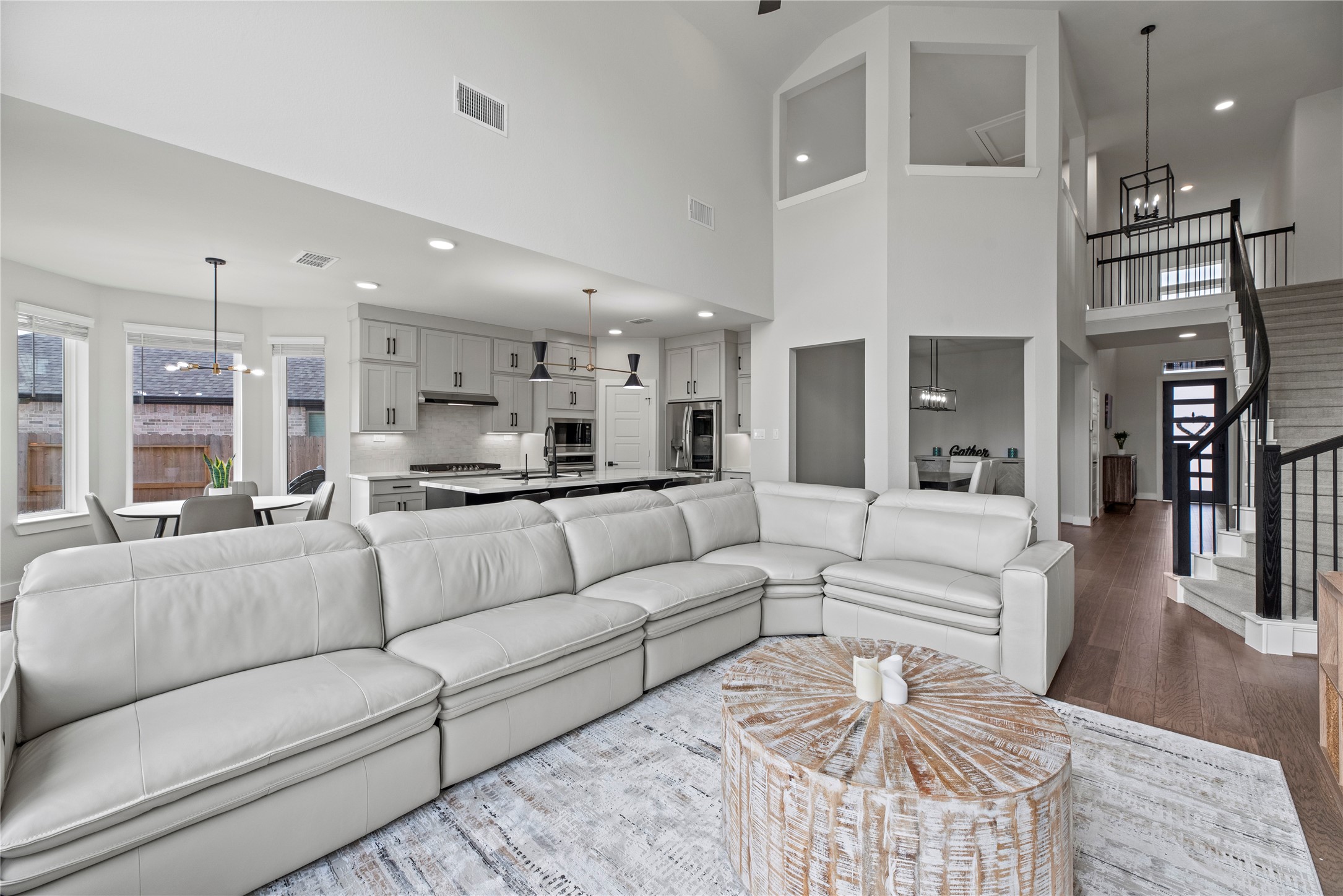 30155 GOLD FINCH Place Fulshear, TX 77441 - Photo 5 of 26 The open-concept design thoughtfully connects the living, dining, and kitchen areas, creating a seamless and versatile space.