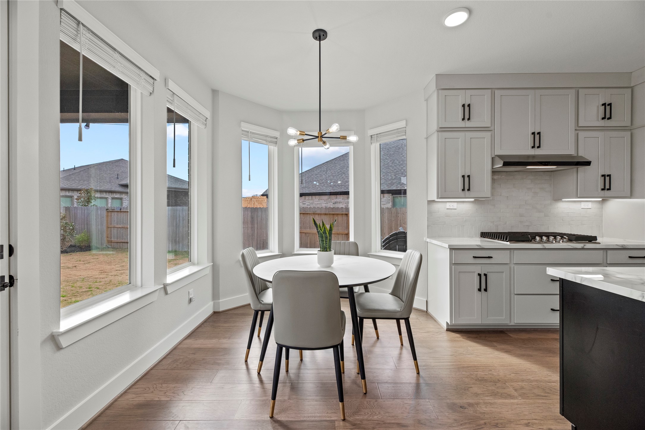 30155 GOLD FINCH Place Fulshear, TX 77441 - Photo 10 of 26 The breakfast room is ideal for a full-sized table and features gorgeous large bright windows overlooking the picturesque backyard and lovely overhead chandelier.