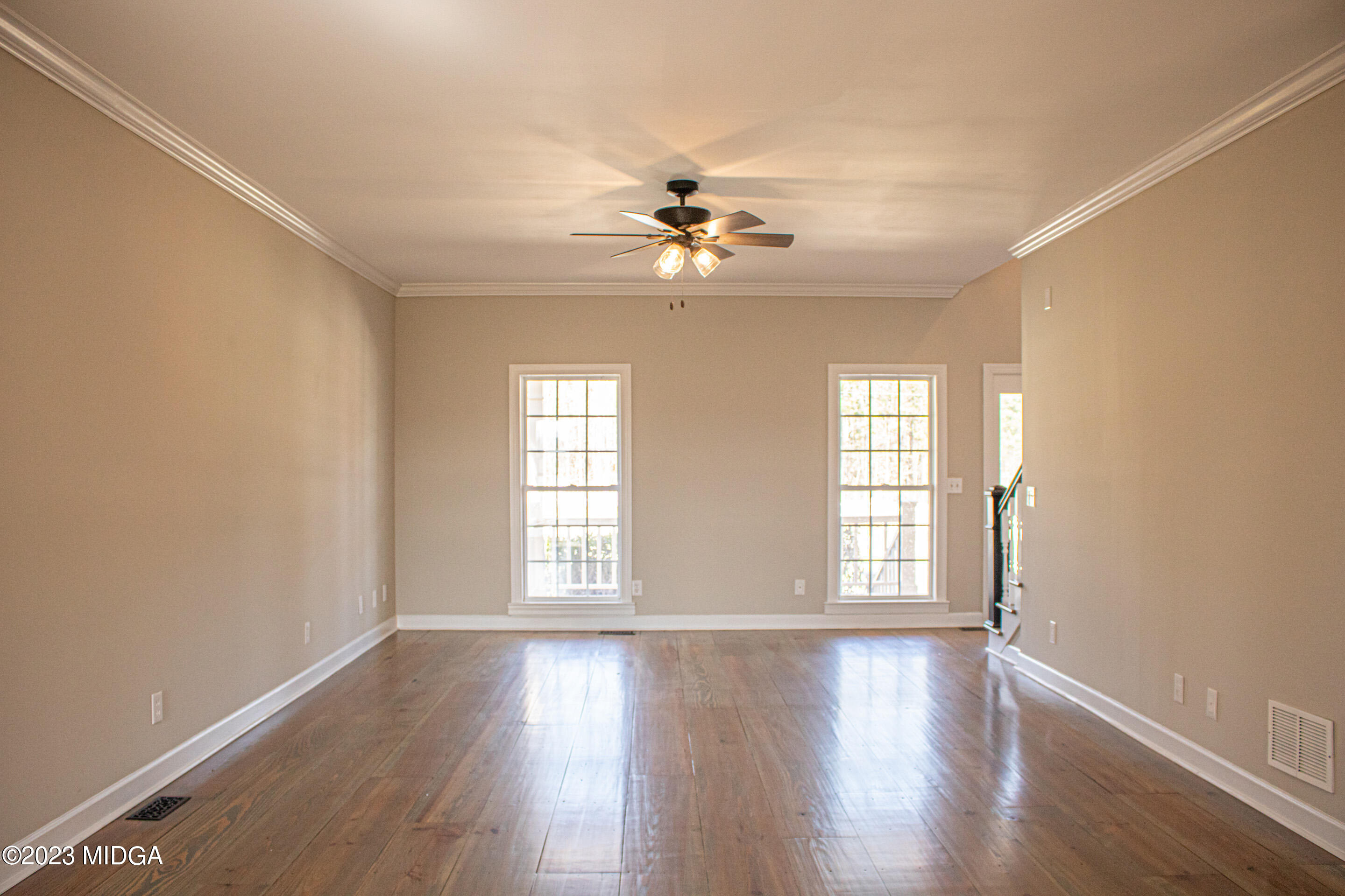 829 Lassiter Road Forsyth, GA 31029 - Photo 12 of 85 an empty room with wooden floor and windows