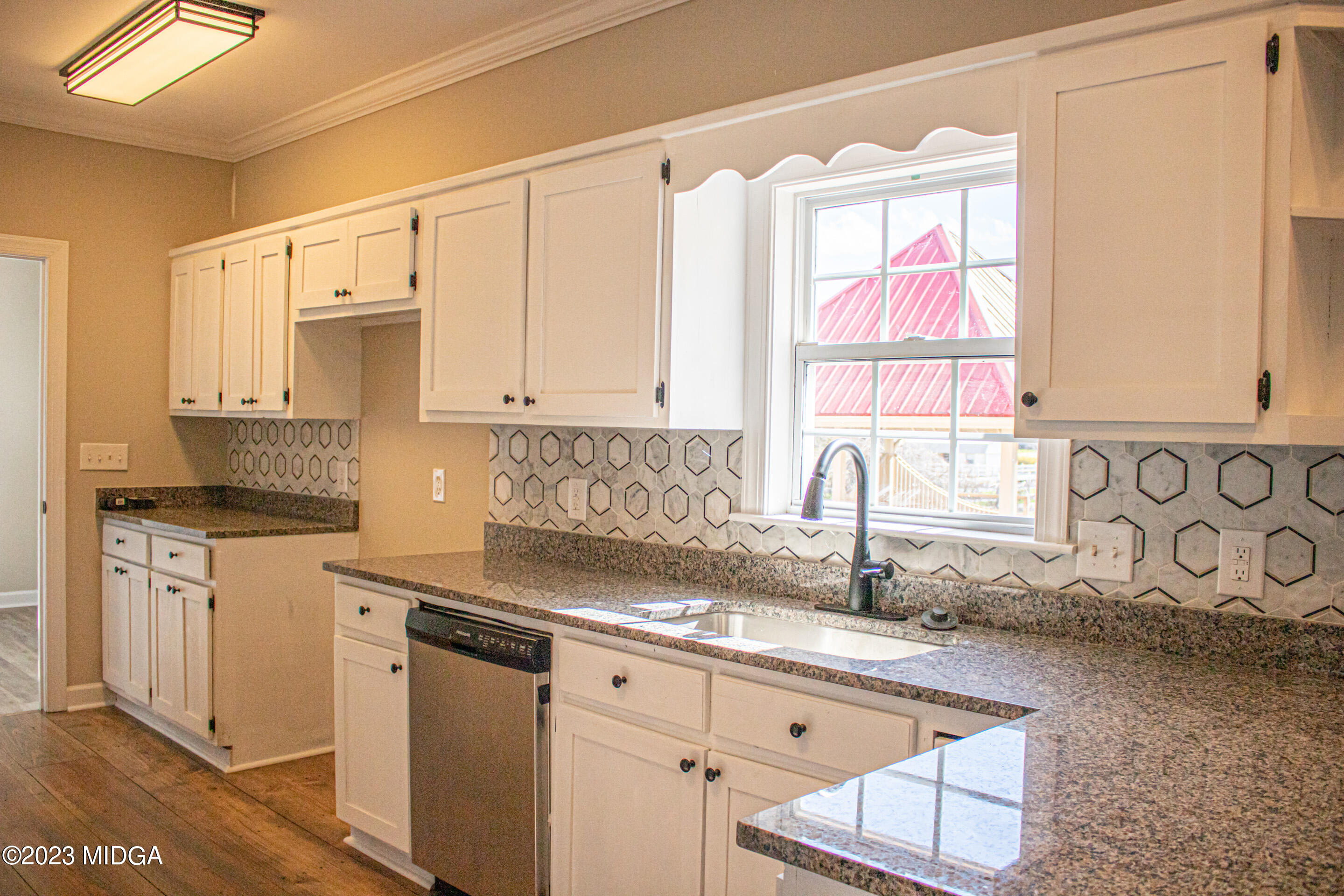829 Lassiter Road Forsyth, GA 31029 - Photo 15 of 85 a kitchen with stainless steel appliances granite countertop white cabinets sink and window