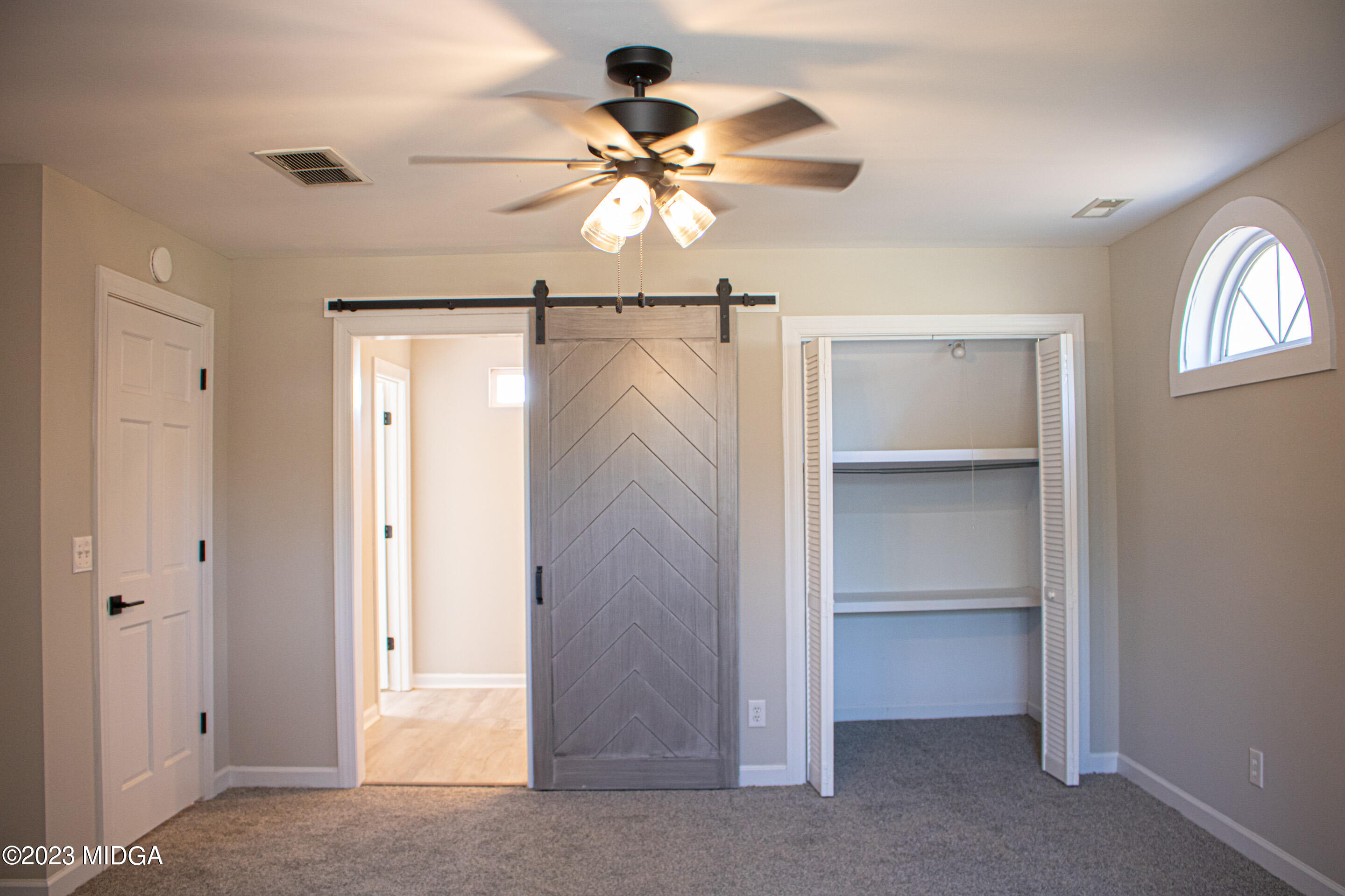 829 Lassiter Road Forsyth, GA 31029 - Photo 28 of 85 a view of a livingroom with a ceiling fan and a window