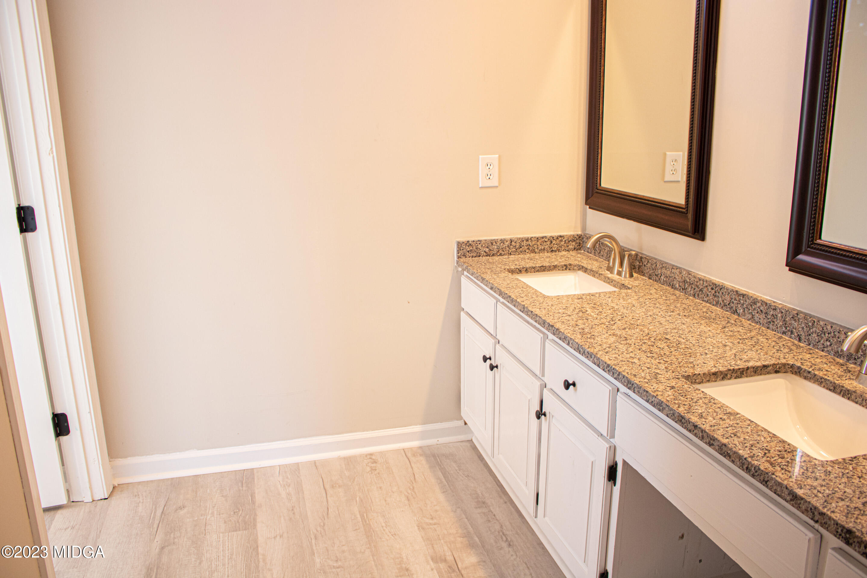 829 Lassiter Road Forsyth, GA 31029 - Photo 29 of 85 a bathroom with a granite countertop sink and a mirror