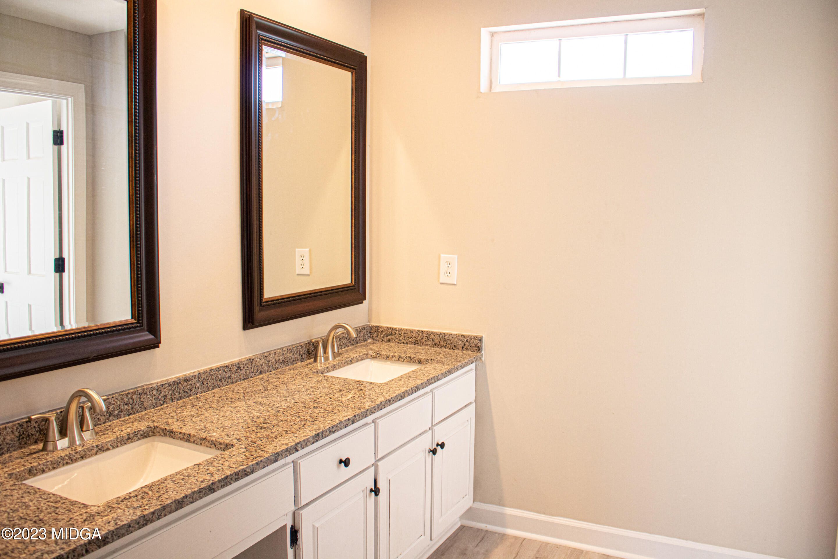 829 Lassiter Road Forsyth, GA 31029 - Photo 34 of 85 a bathroom with a granite countertop sink and a mirror