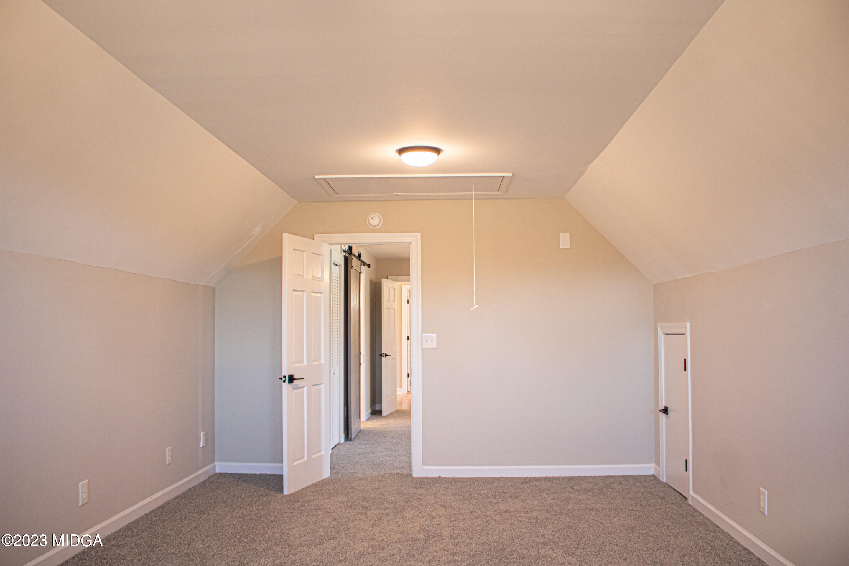 829 Lassiter Road Forsyth, GA 31029 - Photo 36 of 85 a view of a hallway with wooden shelves