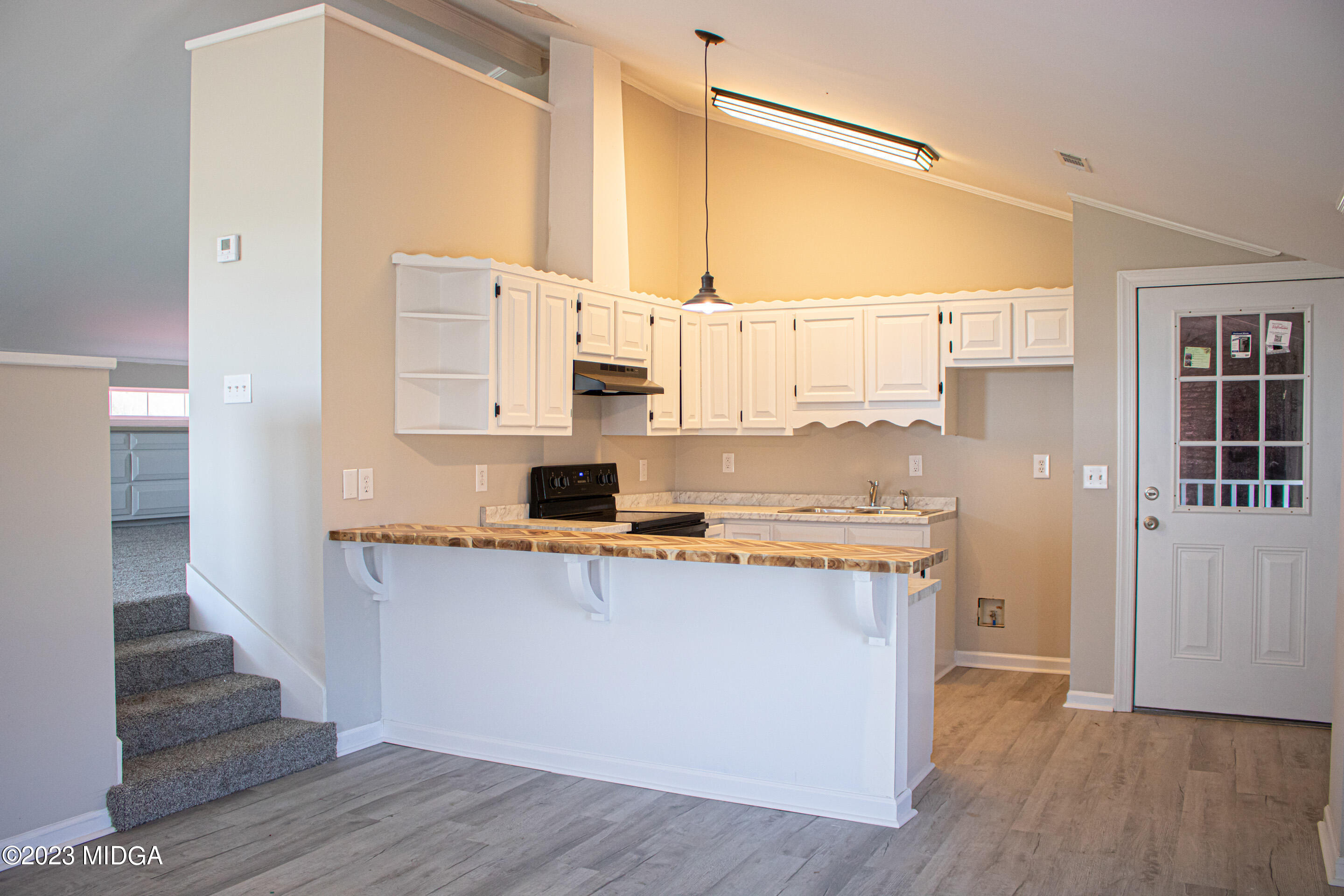 829 Lassiter Road Forsyth, GA 31029 - Photo 57 of 85 a kitchen with stainless steel appliances a stove top oven a sink and cabinets