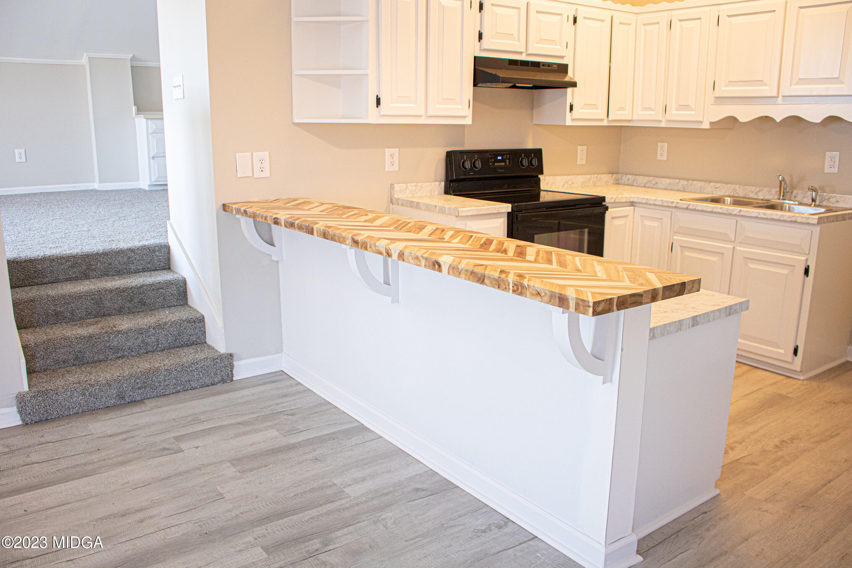 829 Lassiter Road Forsyth, GA 31029 - Photo 60 of 85 a kitchen with stainless steel appliances granite countertop a stove a sink and a refrigerator