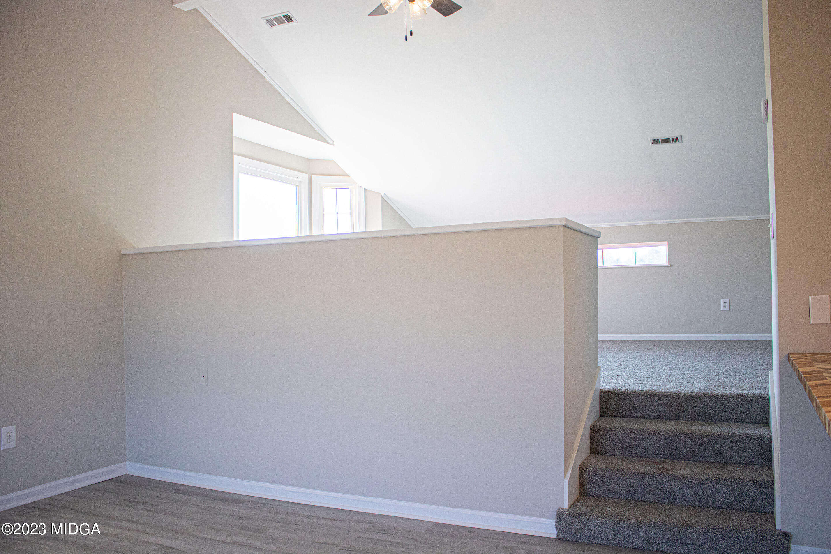 829 Lassiter Road Forsyth, GA 31029 - Photo 61 of 85 a view of an empty room with wooden floor and a window