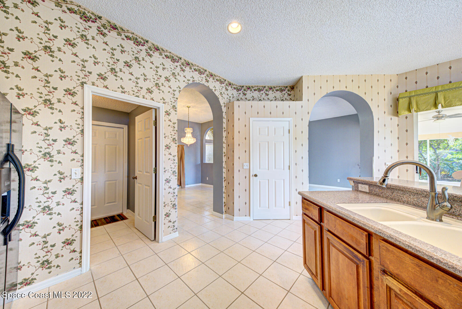 1241 Winding Meadows Road Rockledge, FL 32955 - Photo 28 of 54 kitchen & laundry room