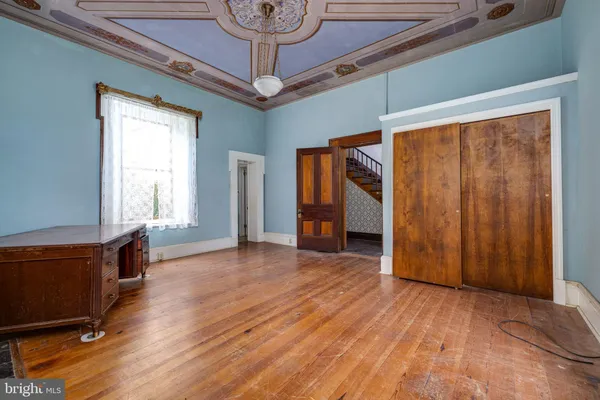 a view of an empty room with a fireplace