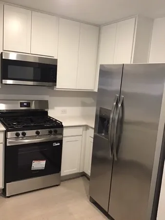 a kitchen with a stove and a microwave